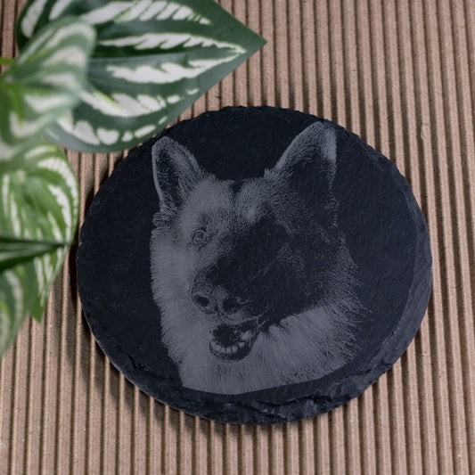Round black slate coaster with a engraved dog design