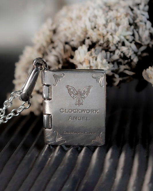 Customizable hinged silver book pendant with a Clockwork Angel design.