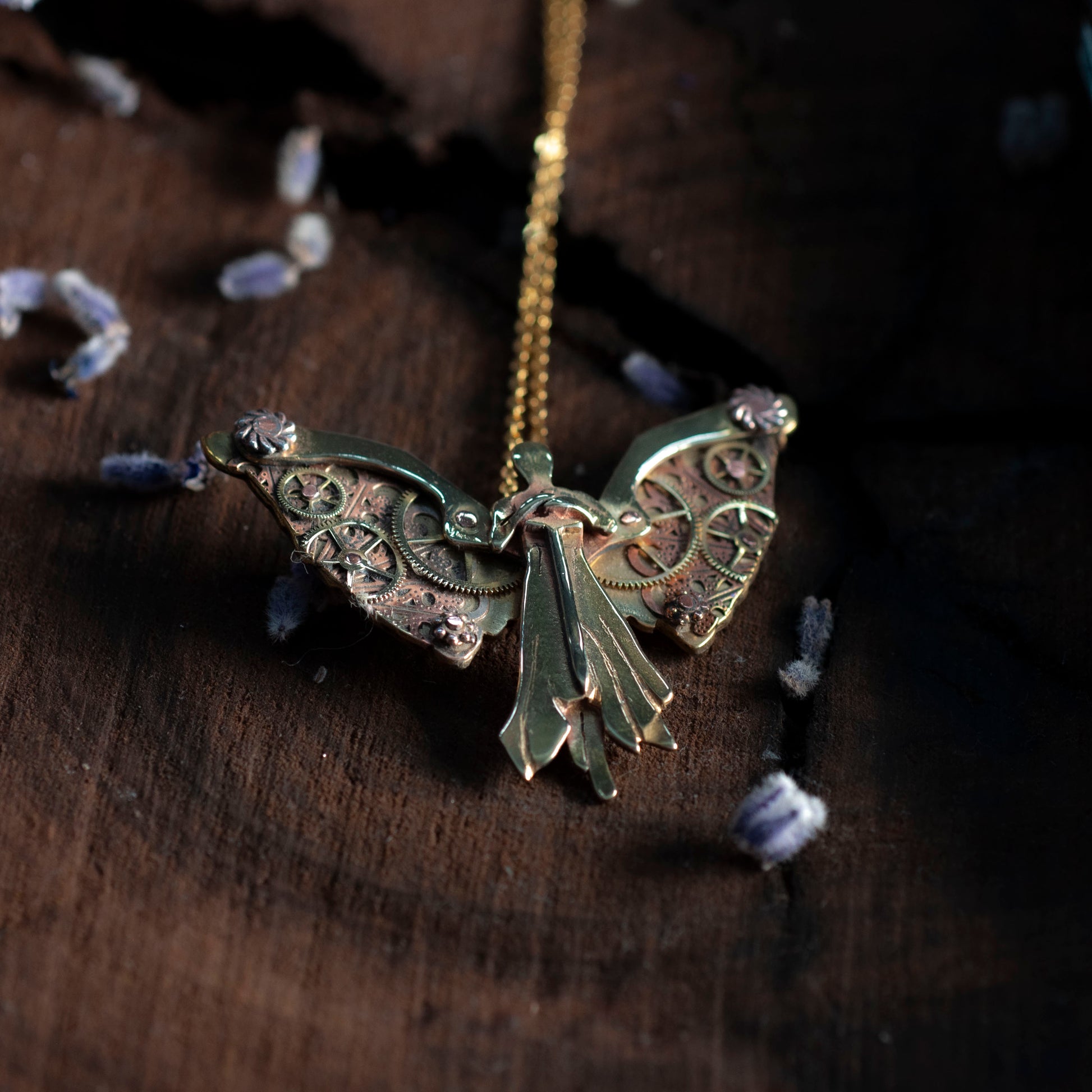 Detail view of Tessa's clockwork angel necklace