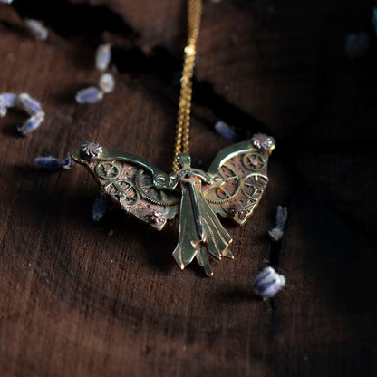 Detail view of Tessa's clockwork angel necklace