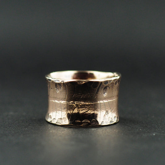 Close-up of the engraved leaf skeleton texture on the brass ring